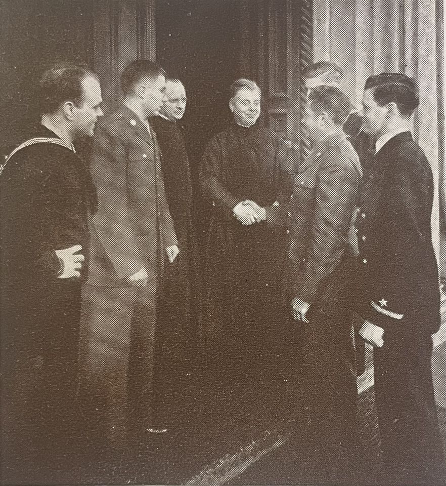 President of Saint Ignatius Fr. Nicholas Mann, S.J., with Fr. Bilstein at his left, welcomes back alumni who had served to campus. (1943)